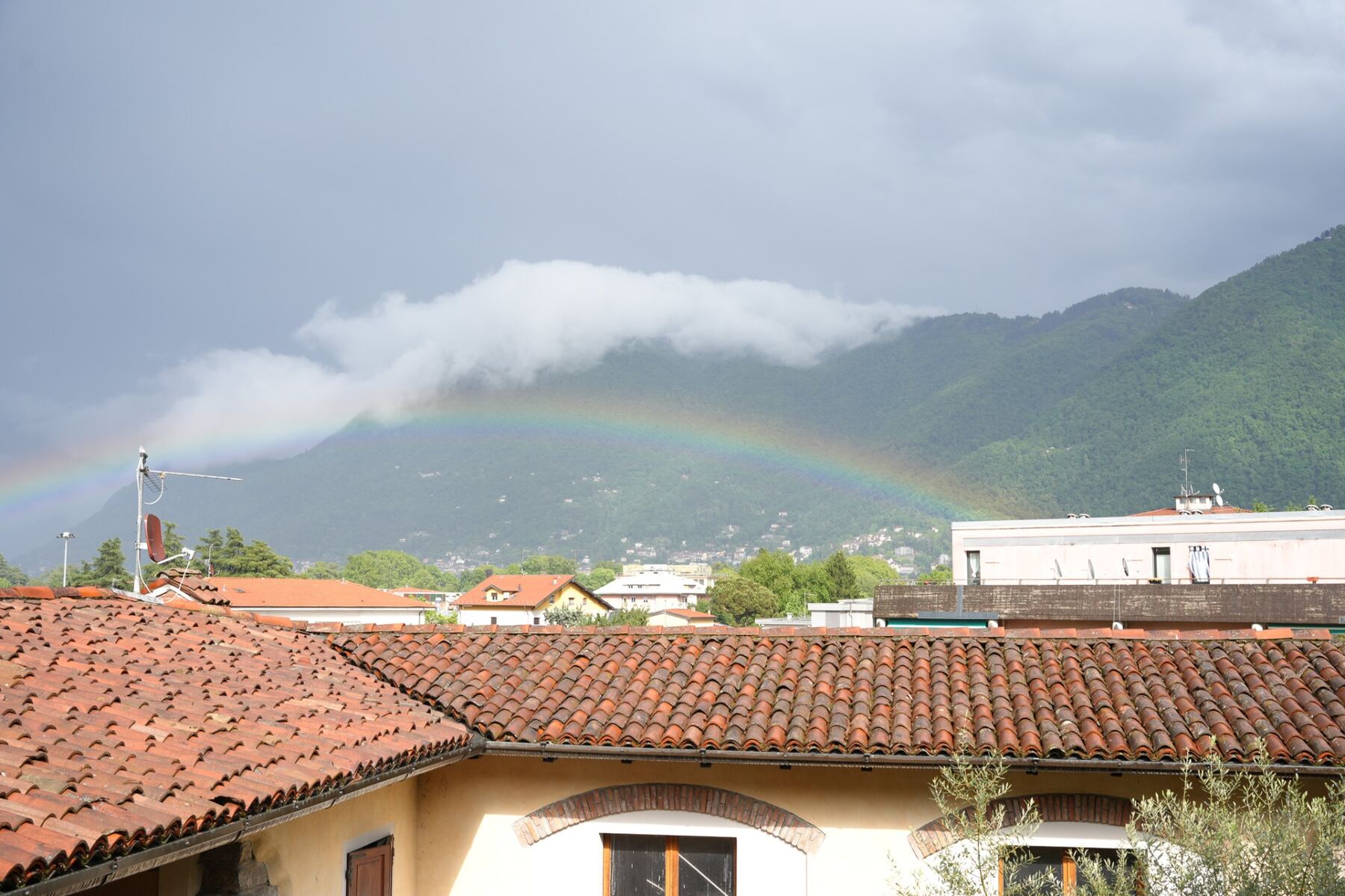 Rainbow over Como rooftops